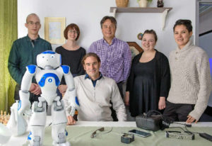 Group picture with NAO robot: Project lead Daniel Sonntag (seated) and some members of his team at DFKI. Photo: Oliver Dietze